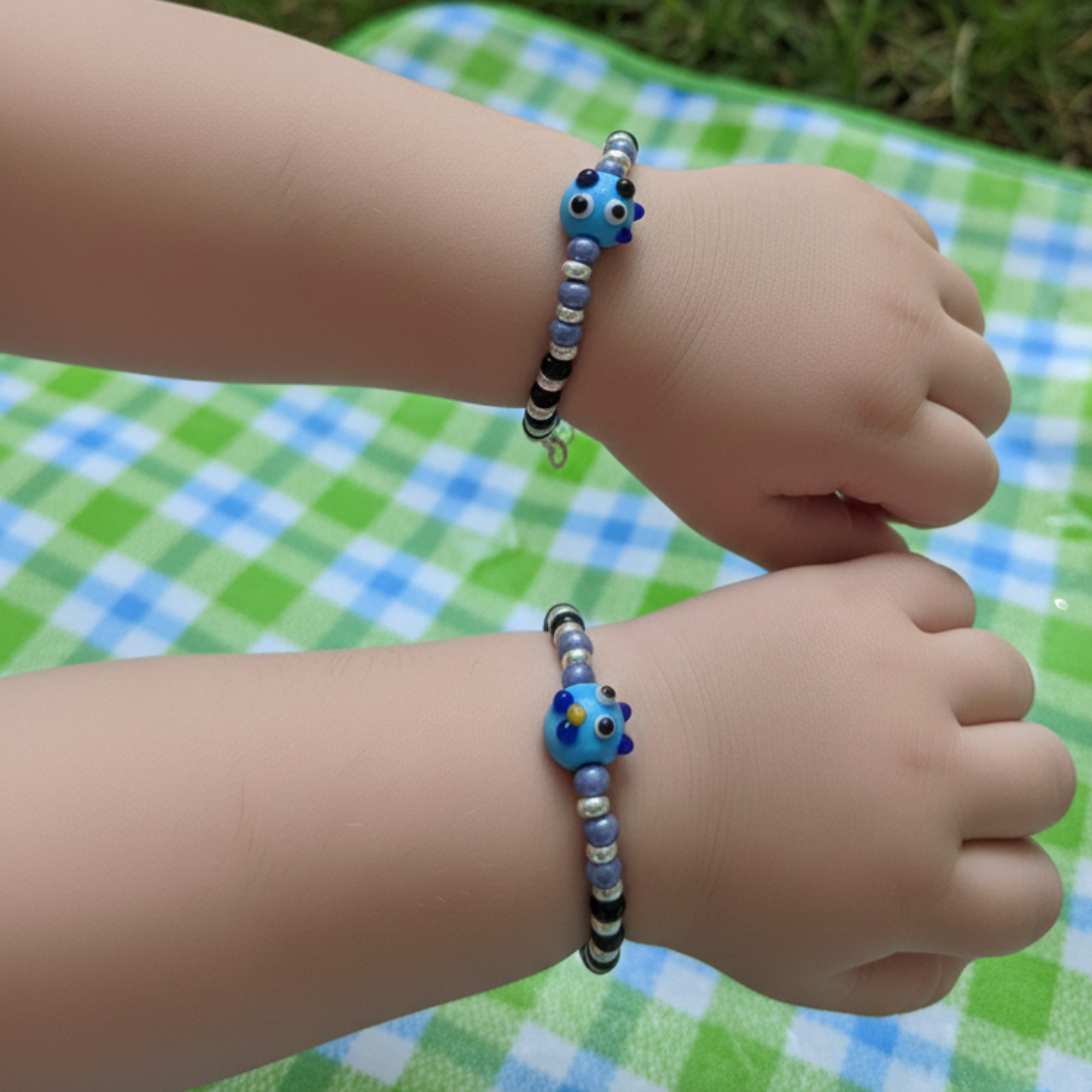 Charming Black and Silver Beaded Bracelet with Whimsical Blue Cartoon Glass Centerpiece.